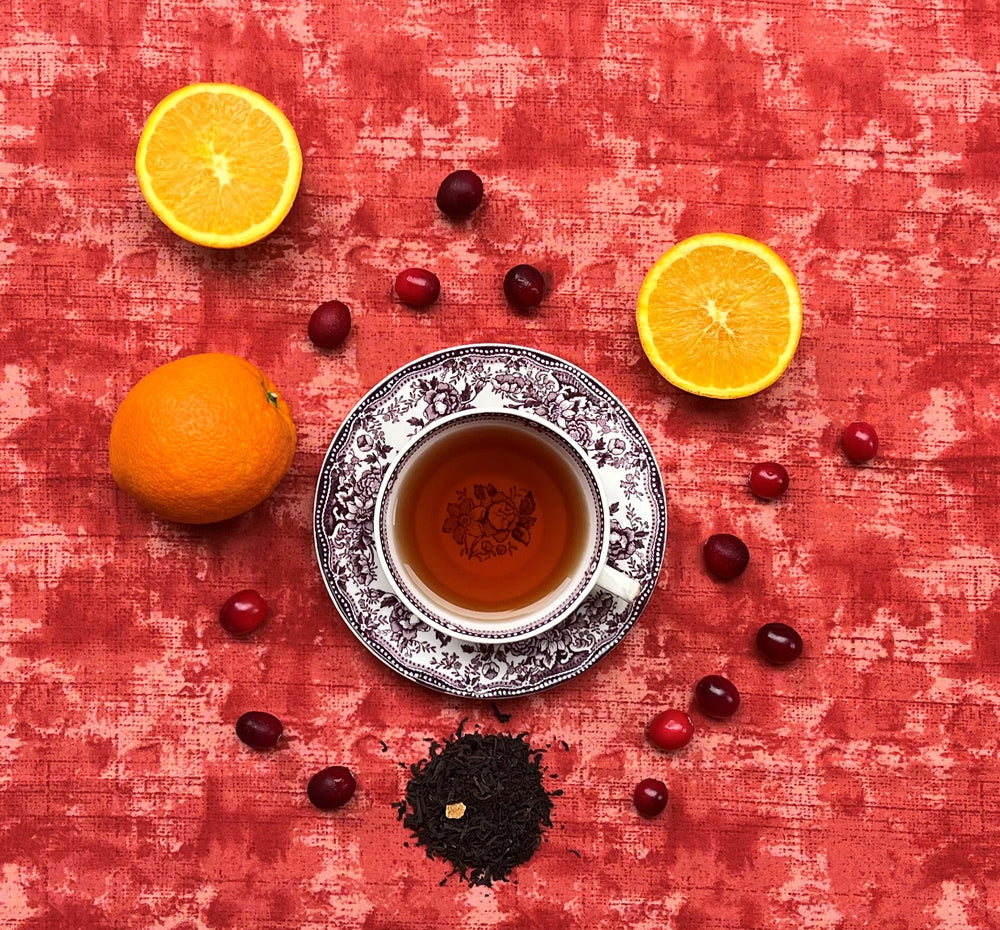 Orange Cranberry Black Tea Brewed in Teacup w/ Oranges and Cranberries
