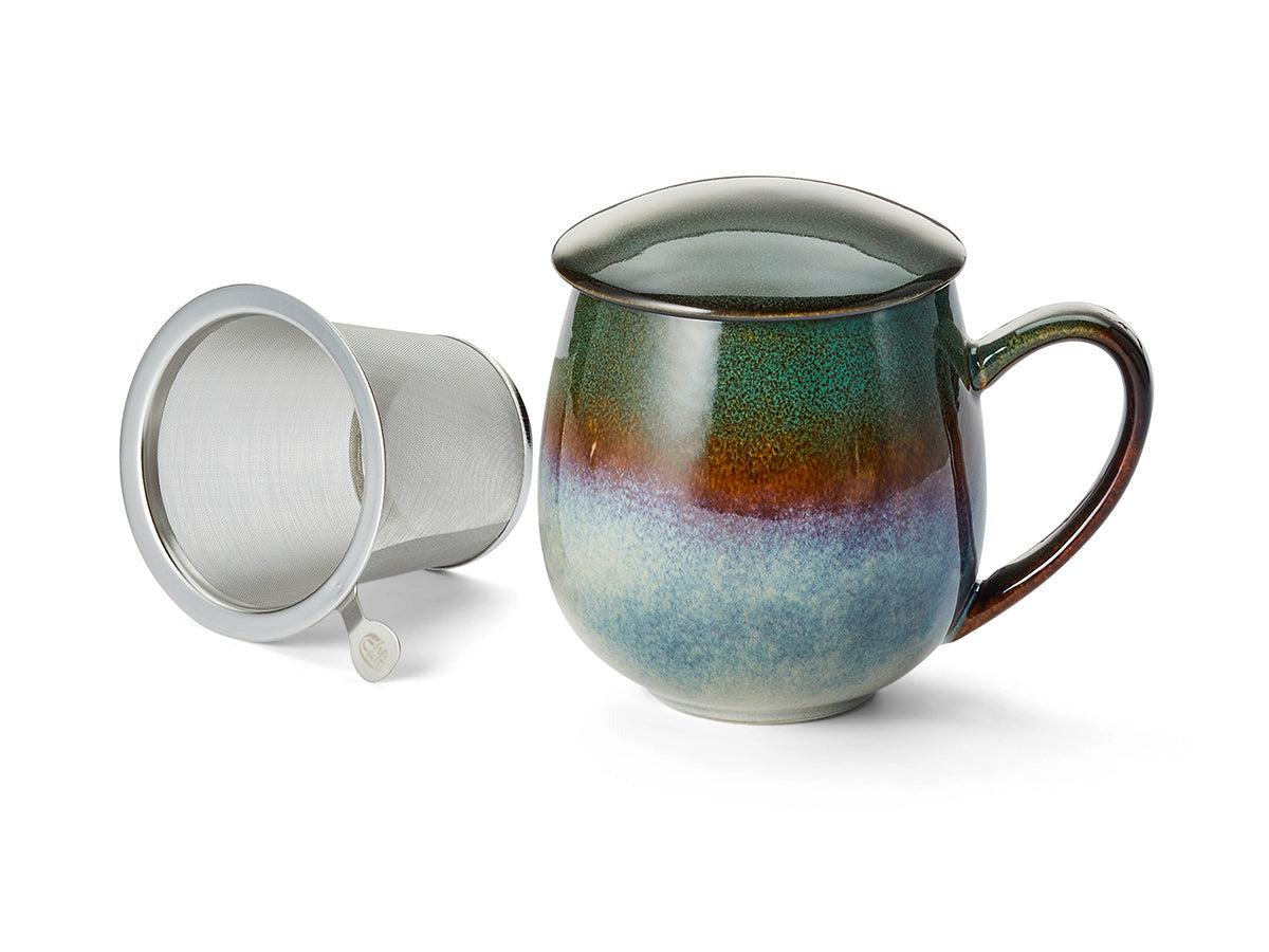 Multicolored ceramic mug with a metal filter on a white background