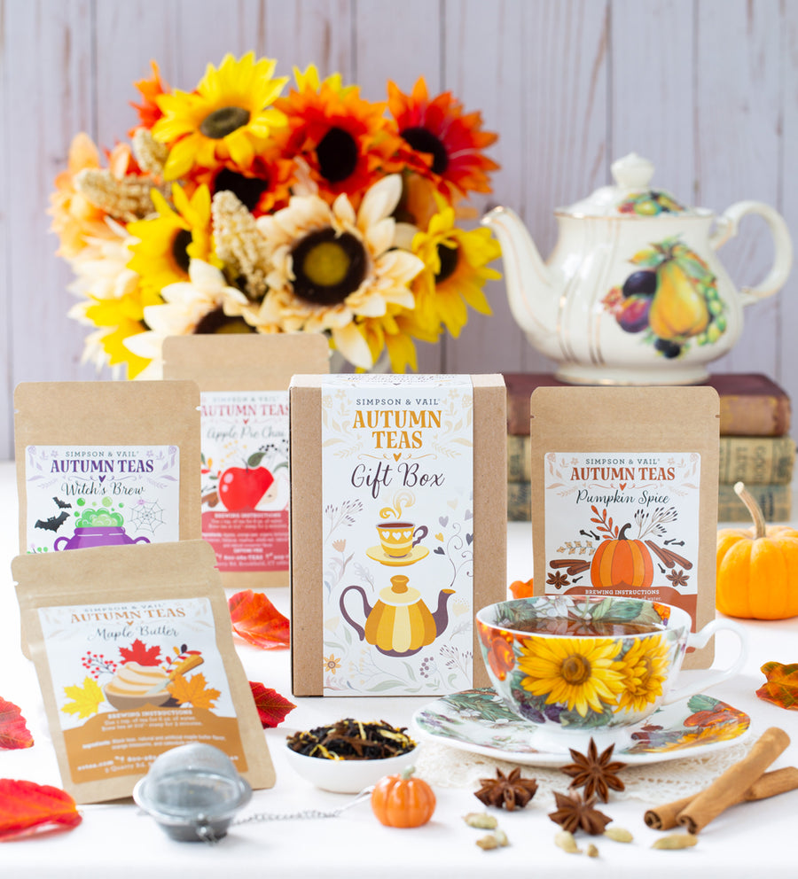 Tea packaging with autumn-themed design, sunflowers, and a teapot in the background.