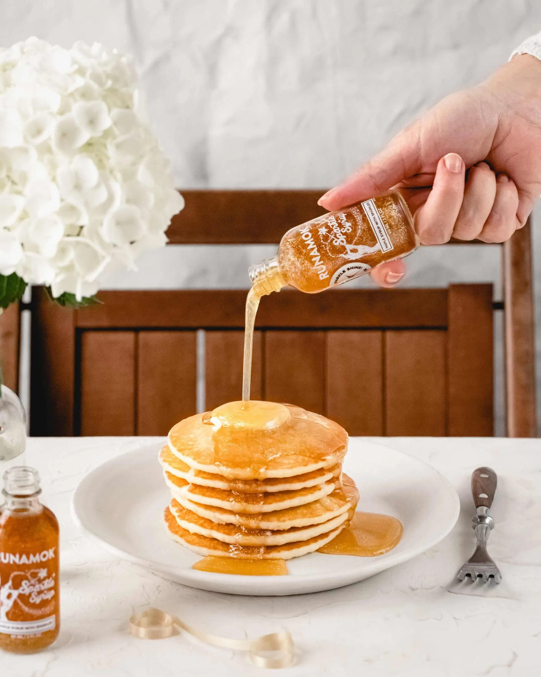 mini runamok sparkle syrup pouring on pancakes 