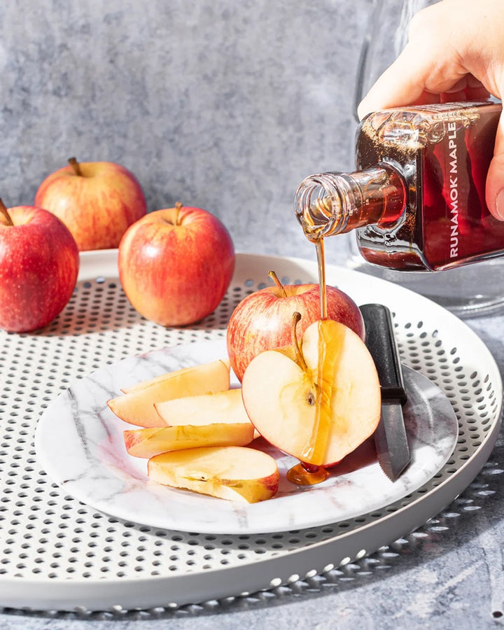 runamok pumpkin spice infused maple syrup pouring on apples